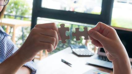Hand team put missing jigsaw puzzle on the air