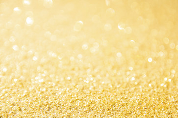 Defocused gold glitter background. Gold abstract bokeh background. Christmas abstract background