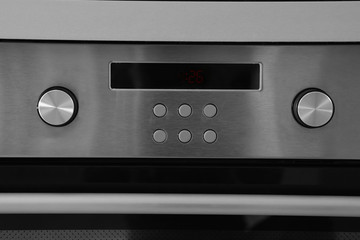 Oven setting panel with display and buttons, closeup
