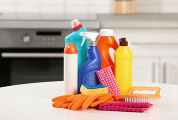 Set of cleaning supplies on table in kitchen