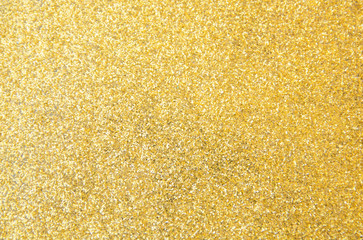 Defocused gold glitter background. Gold abstract bokeh background. Christmas abstract background