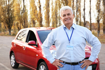 Senior instructor near modern car outdoors. Get driving license