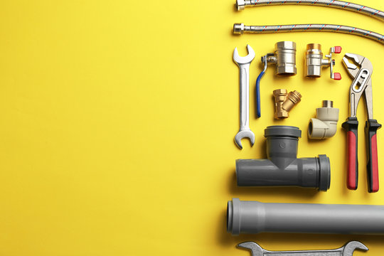 Flat lay composition with plumber's tools and space for text on color background