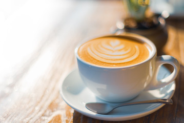 A bright image of a perfect coffee on a wooden table taken on a sunny day in LA