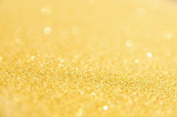 Defocused gold glitter background. Gold abstract bokeh background. Christmas abstract background