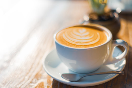 A bright image of a perfect coffee on a wooden table taken on a sunny day in LA