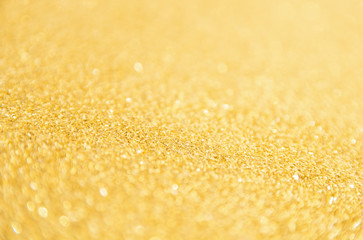 Defocused gold glitter background. Gold abstract bokeh background. Christmas abstract background