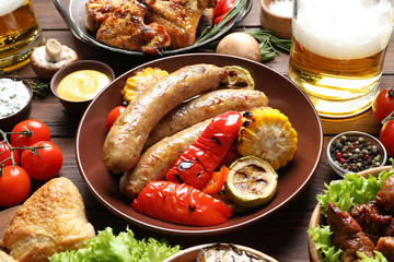 Delicious meal served for barbecue party on wooden table