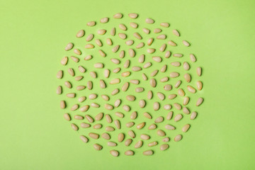 Flat lay composition with pine nuts on color background