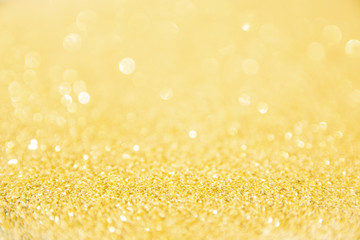 Defocused gold glitter background. Gold abstract bokeh background. Christmas abstract background