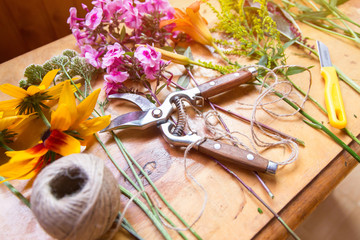 Florist workplace. Flowers and tools to create a bouquet on a table