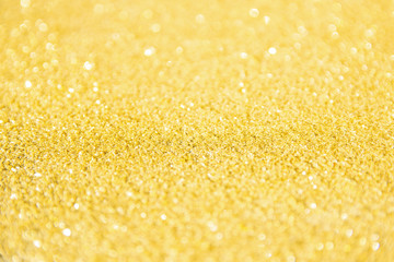 Defocused gold glitter background. Gold abstract bokeh background. Christmas abstract background