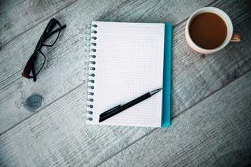 notepad with coffee and glasses