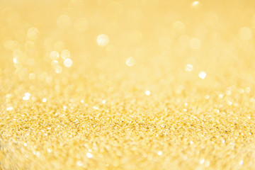 Defocused gold glitter background. Gold abstract bokeh background. Christmas abstract background