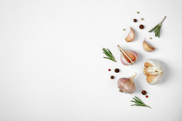 Composition with garlic, pepper and rosemary on white background, top view. Space for text