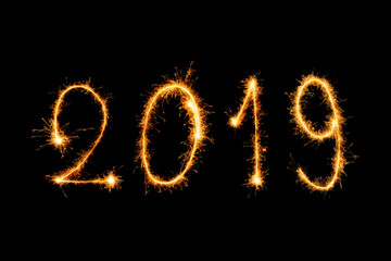 Obraz na płótnie Canvas 2019 Happy new year text with sparkle fireworks isolated on black