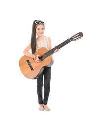 Obraz premium Little cheerful girl playing guitar, isolated on white