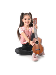 Little cheerful girl with guitar, isolated on white