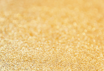 Defocused gold glitter background. Gold abstract bokeh background. Christmas abstract background
