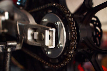 Close-up of a competition motorcycle chain in natural light.