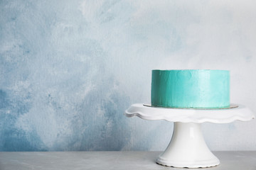Fresh delicious birthday cake on stand against color background. Space for text