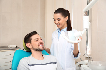 Professional dentist working with patient in modern clinic