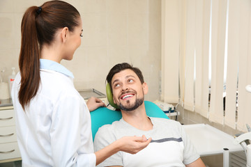 Professional dentist working with patient in modern clinic