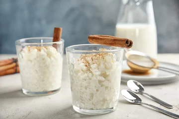  Creamy rice pudding with cinnamon in glasses on table © New Africa