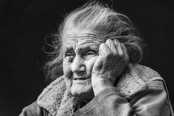 Very old and tired wrinkled woman outdoors