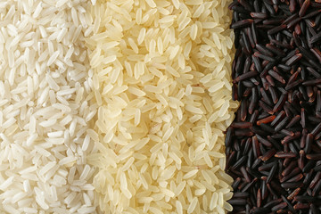 Brown and other types of rice as background, closeup