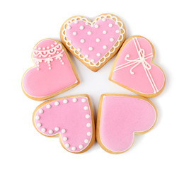 Decorated heart shaped cookies on white background, top view