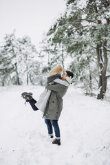Fototapeta na wymiar Happy Couple Having Fun Outdoors in Snow Park.