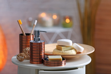 Composition with soap and toiletries on table against blurred background. Space for text