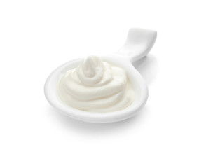 Serving spoon with sour cream on white background