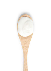Wooden spoon with sour cream on white background, top view