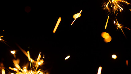 Christmas sparkler isolated on black background. Bengal fire