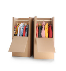 Cardboard wardrobe boxes with clothes on white background