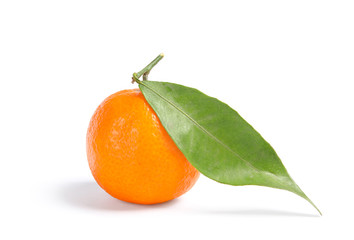 Tasty ripe tangerine with leaf on white background