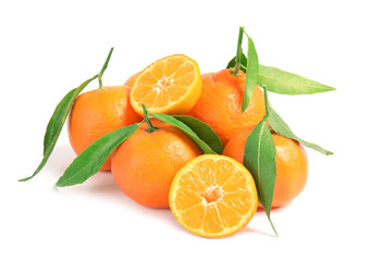 Tasty ripe tangerines with leaves on white background