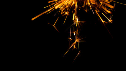 Christmas sparkler isolated on black background. Bengal fire