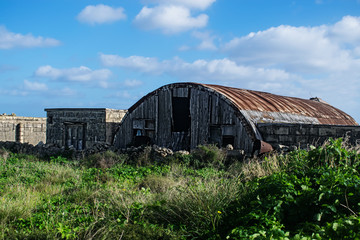 Fototapeta na wymiar Abandoned Iron Hut in the Countryside