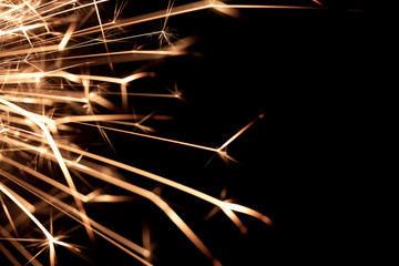 Christmas sparkler isolated on black background. Bengal fire