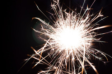Christmas sparkler isolated on black background. Bengal fire