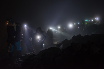 Fototapeta na wymiar Climbers walking in the mountain path of the night