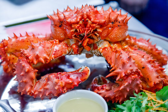 Closeup Of Delicious Tasty Boiled Freshly Prepared Red King Crab On Metal Dish With Lemon, Greens, Sauce. Concept Expensive Food, Smuggling, Vip Delivery, Elite, Luxury Appetizer