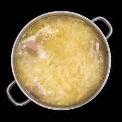 Shurpa soup in a large pan, top view, isolated on black