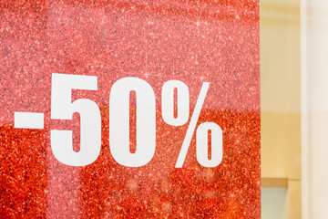Special sale up to 50 off text on a glass wall, a view inside the popular clothing store.The final sale, 50,clothing boutique. discounts.sale 50 off mock up advertise display,shopping, business and
