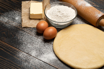 rolled and unbaked Shortcrust pastry dough recipe on wooden background