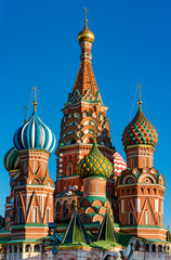 Fototapeta na wymiar Saint Basils cathedral on Red Square in Moscow. Famous russian landmarks on blue sky background.