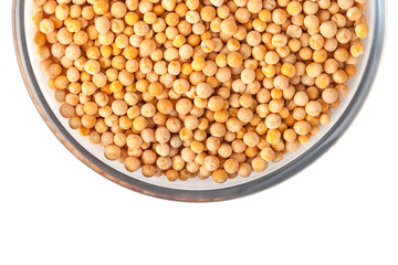 Seeds of peas on glass bowl on white background